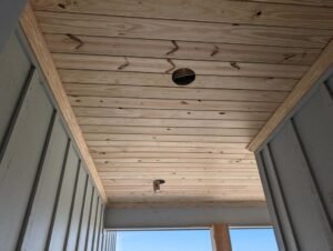 Custom ceiling installation in Lafayette, LA by WTH Construction, featuring tongue and groove pine.
