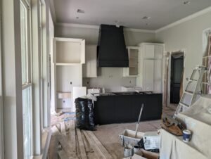 Kitchen renovation project in Lafayette, LA by WTH Construction, showcasing a modern black and white design.