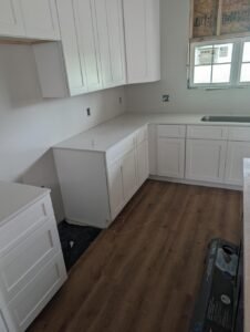 Kitchen renovation project in Lafayette, LA by WTH Construction, featuring white shaker cabinets and quartz countertops.